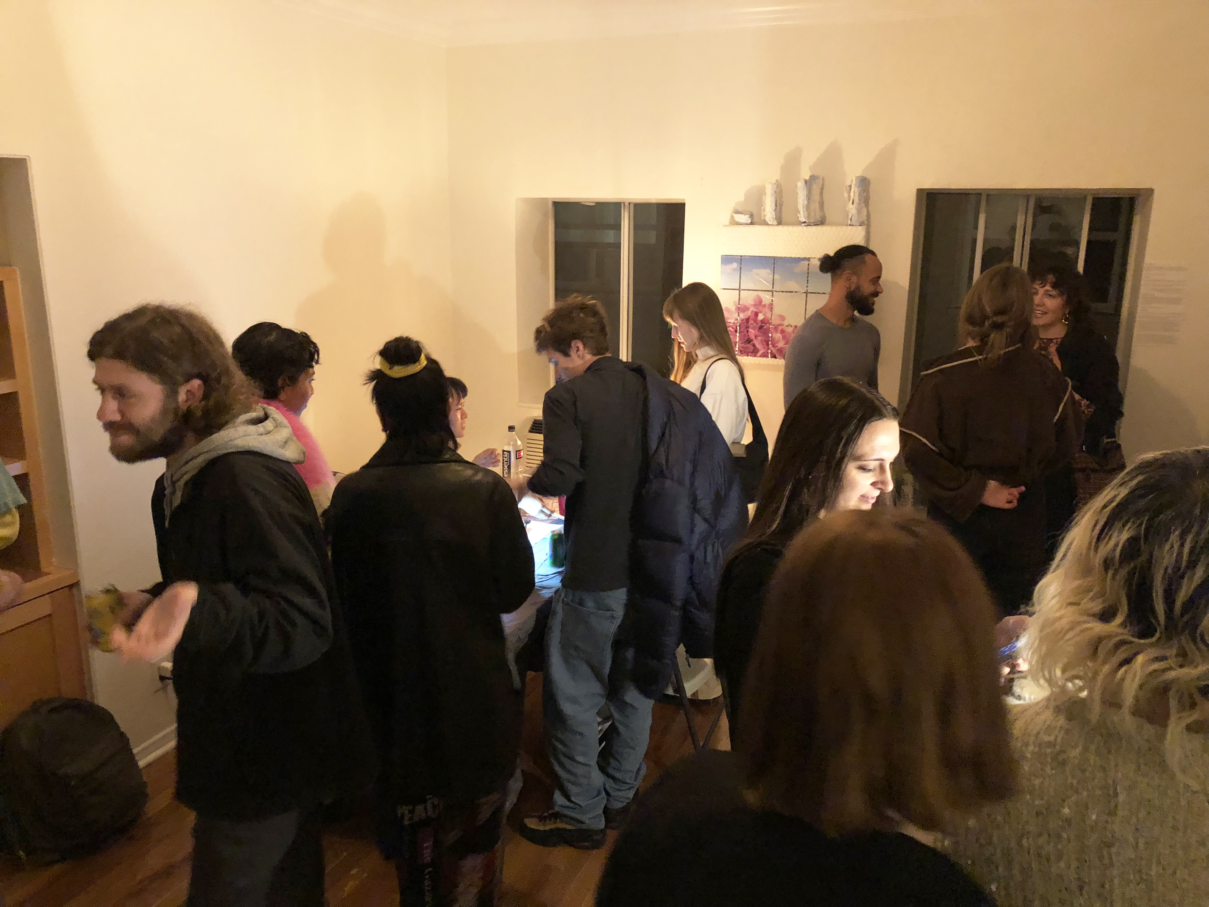 Crowd of people socializing in a small room